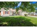 Lovely one-story home with red shutters, a manicured lawn, and mature shade trees at 7030 Kingston Ln, Mcdonough, GA 30253