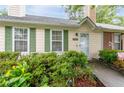 Inviting one-story home with green shutters, a manicured yard, and brick accents for added character at 1926 Cheatham Woods Sw Dr, Marietta, GA 30008