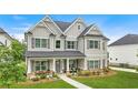 Beautiful two-story home with manicured lawn, stone accents, and covered front porch at 2326 Britt St, Grayson, GA 30017