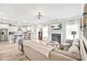 Open-concept living room with fireplace, hardwood floors, and seamless flow into the modern kitchen at 2326 Britt St, Grayson, GA 30017
