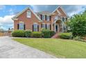 Lovely brick home showcasing a well-manicured lawn and driveway, enhancing its curb appeal at 2684 Mountain Oaks Ct, Powder Springs, GA 30127