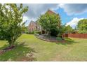 Well-maintained lawn and landscaping around a brick home, providing an inviting and picturesque setting at 2684 Mountain Oaks Ct, Powder Springs, GA 30127