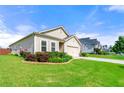 Beautifully landscaped lawn around this single Gathering home featuring a two-car garage and patriotic American flag at 3735 Westhaven Dr, Cumming, GA 30040