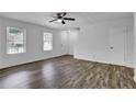 Light-filled living room showcasing wood-look flooring, white walls, and a ceiling fan at 4520 Coopers Creek Se Cir, Smyrna, GA 30082
