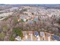 Aerial view showcasing homes near community amenities, including pool, playground, and tennis courts at 4865 Fourth Rail Ln, Cumming, GA 30040