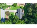 Aerial view of a home with mature trees, showcasing the roof and lot at 1066 Sea Oats Sw Way, Lilburn, GA 30047