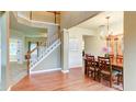 Inviting entryway with hardwood floors, stairs, and dining area with chandelier at 1810 Stardust Trl, Cumming, GA 30040