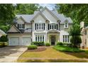 Charming traditional-style home with lush landscaping and a two-car garage at 2055 Beacon Hill Way, Alpharetta, GA 30005