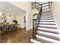 Elegant foyer with hardwood floors, staircase, and views into the dining room at 2055 Beacon Hill Way, Alpharetta, GA 30005