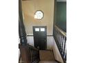 Entryway with dark trim, wooden stairs, decorative light fixture, and tiled stairs at 2475 Cajun Dr, Marietta, GA 30066