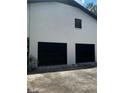 Attached two-car garage featuring modern, black door on a white brick building at 2475 Cajun Dr, Marietta, GA 30066