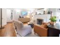 Bright living room featuring a fireplace, hardwood floors, and stylish decor at 401 Emory Ne Dr, Atlanta, GA 30307