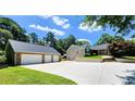 View of the home and detached three-car garage with a long driveway at 5300 Haynes Creek Dr, Loganville, GA 30052