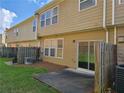 Spacious backyard with patio and view of other townhomes at 1865 Ellison Lakes Nw Ct # 21, Kennesaw, GA 30152