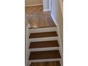 Close up of staircase with freshly painted white risers and stained treads at 1865 Ellison Lakes Nw Ct # 21, Kennesaw, GA 30152