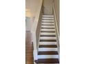Classic staircase with white risers and stained treads leading to the upper level at 1865 Ellison Lakes Nw Ct # 21, Kennesaw, GA 30152