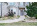 Inviting front entrance with beautifully landscaped walkway leading to a decorative front door at 3739 In Bloom Way, Auburn, GA 30011
