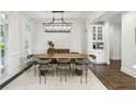 Elegant dining room with modern lighting, perfect for entertaining with stylish decor and ample seating at 4944 Dovecote Trl, Suwanee, GA 30024