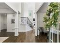 Bright foyer with hardwood floors and staircase, creating a welcoming entrance with natural light and inviting design at 4944 Dovecote Trl, Suwanee, GA 30024