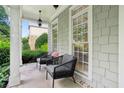 Cozy front porch with comfortable seating, offering a relaxing outdoor space with charming curb appeal at 4944 Dovecote Trl, Suwanee, GA 30024
