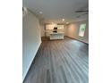 Open concept living area with hard surface floors and a kitchen featuring an island with modern appliances at 107 Deer Xing, Temple, GA 30179