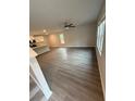 Spacious living room with gray wood flooring, ceiling fan, bright natural light, and vaulted ceilings at 107 Deer Xing, Temple, GA 30179