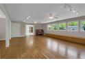 Bright living room with hardwood floors, neutral walls, track lights, windows, and doorway access at 4102 Barr Cir, Tucker, GA 30084