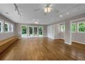 Spacious living room featuring hardwood floors, many windows, and multiple ceiling fans to provide optimal comfort at 4102 Barr Cir, Tucker, GA 30084