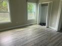 Bright bedroom with wood-look flooring, complemented by natural light streaming through the window at 841 N North Price Rd, Sugar Hill, GA 30518