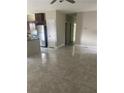 Open concept living space with tile floors, stainless steel refrigerator, and view to the kitchen at 841 N North Price Rd, Sugar Hill, GA 30518
