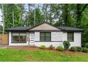 Charming home boasts freshly painted exterior, large windows, green lawn, and tasteful landscaping at 1719 San Gabriel Ave, Decatur, GA 30032