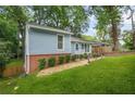 Charming exterior showcasing a well-kept lawn and classic architectural details at 4981 Crowe Se Dr, Smyrna, GA 30082