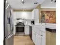 Kitchen boasts stainless steel appliances, white cabinets, and stylish backsplash at 1101 Juniper Ne St # 922, Atlanta, GA 30309