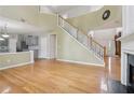 Open-concept living space featuring hardwood floors, a staircase, and neutral wall color at 112 Rotherhithe Nw Ln, Marietta, GA 30066