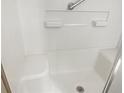 Accessible shower with grab bar and built-in shelving, designed for safety and convenience at 475 Mount Vernon Ne Hwy # C230, Sandy Springs, GA 30328