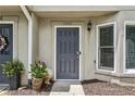 Close up of unit number 1002's front door with potted plants and hardware at 1002 Defoors Nw Lndg, Atlanta, GA 30318