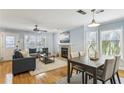Open-concept living and dining area featuring hardwood floors and natural light at 1002 Defoors Nw Lndg, Atlanta, GA 30318
