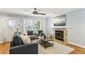 Cozy living room with a fireplace, ceiling fan, and comfortable seating at 1002 Defoors Nw Lndg, Atlanta, GA 30318