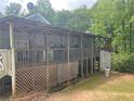Spacious covered back porch featuring a wooden frame and lattice work, perfect for outdoor relaxation at 36 Wolf Pen Path, Dallas, GA 30157