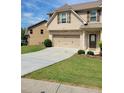 Charming home featuring a two-car garage, landscaped yard, and a welcoming front entrance at 948 Regency Dr, Lawrenceville, GA 30044