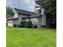Side view of a gray two-story home showing the garage, chimney, and landscaping at 2977 Lowe Ne Trl, Marietta, GA 30066