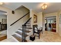 Bright foyer with staircase, tile flooring, and decor leading to a living room area with nice furniture at 5105 Vernon Oaks Dr, Dunwoody, GA 30338