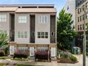 A front exterior view showcasing the townhome's modern facade, private balconies, and well-maintained landscaping at 616 Angier Ne Ave # 4, Atlanta, GA 30308