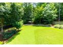 Large, well-maintained backyard featuring a fire pit area and fenced perimeter at 650 Chestatee Creek Nw Dr, Acworth, GA 30101