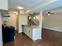 Kitchen boasts granite counters, stainless appliances, with view of the staircase at 1343 Old Coach Sw Rd, Marietta, GA 30008