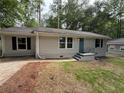 Well-maintained, freshly painted single-story home with a walkway leading to the entrance at 2943 Westbury Dr, Decatur, GA 30033