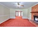 Spacious living room with brick fireplace and an open view to a dining space at 2983 Trotters View Way, Snellville, GA 30039