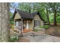 Charming cottage-style home nestled among mature trees and a white picket fence at 778 Mclendon Dr, Decatur, GA 30079