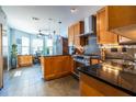 Modern kitchen with granite countertops, stainless steel appliances, wood cabinetry, and eat-in kitchen area at 104 Powell Cv, Decatur, GA 30030
