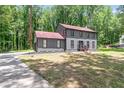 Attractive home featuring gray siding, contrasting black trim, and a well-manicured lawn at 155 N Fayette Dr, Fayetteville, GA 30214